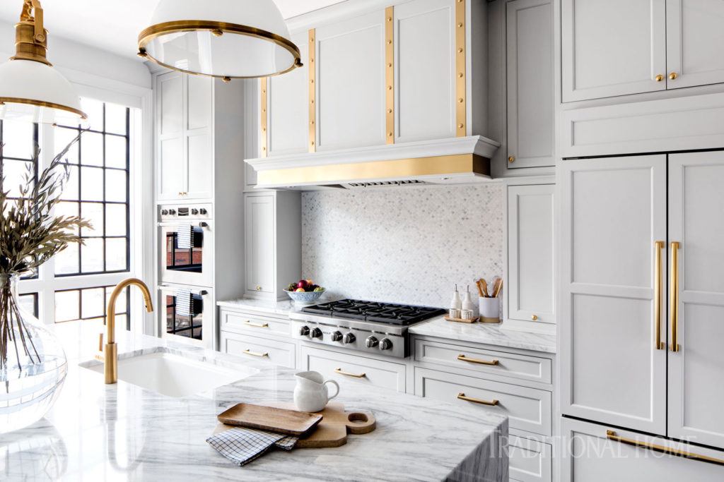 A gray kitchen with brass accents