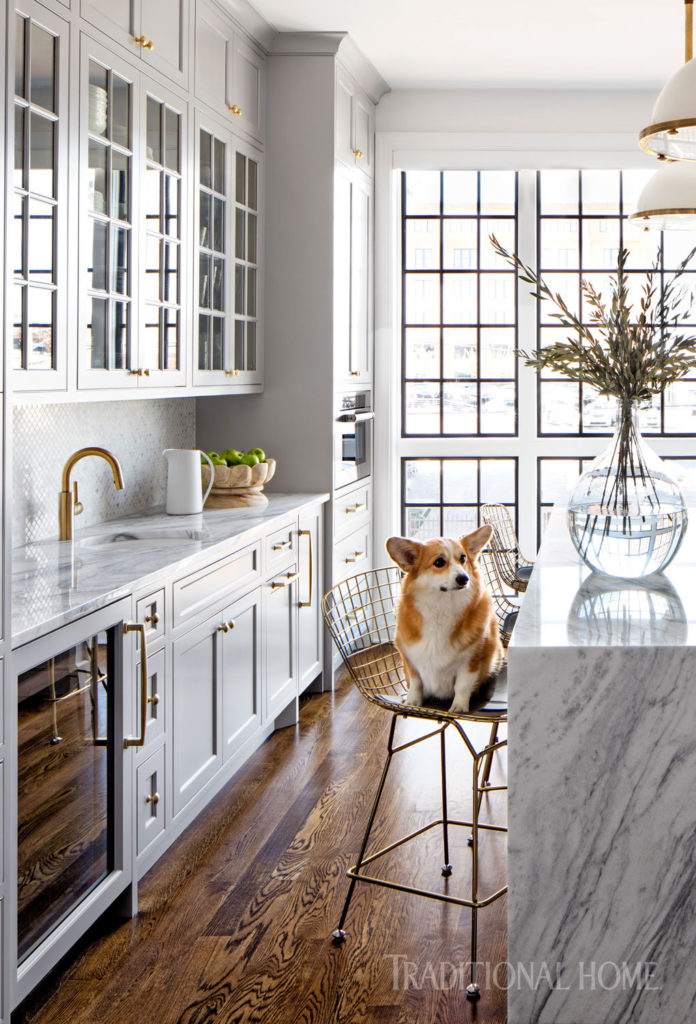 A gray kitchen with brass accents